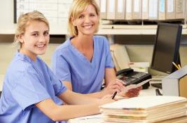 Picture of two nurses at a work desk