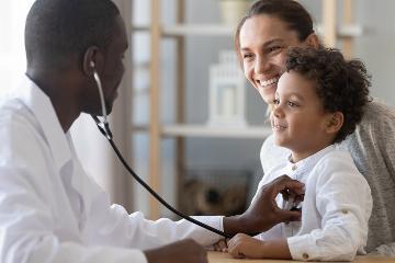 African male pediatrician holding a stethoscope