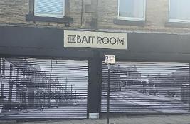 Shutters on a shop with sign saying The Bait Room