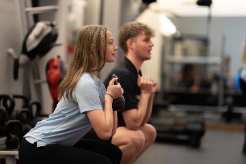 Two people in a gym