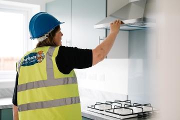 Durham County Council Building Control officer examines kitchen fitting